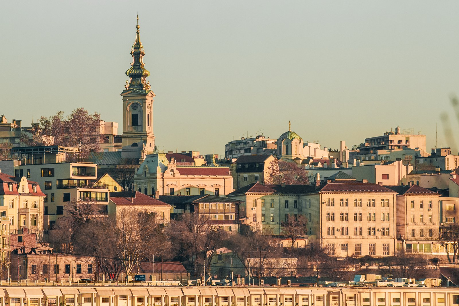The Cathedral Church of the Holy Archangel Michael in Belgrade, its baroque bell tower rising above the rooftops of the old town, seen from the Sava on a winter afternoon